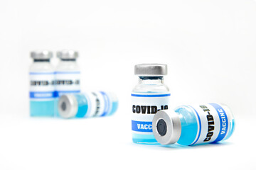 bottles with covid vaccine on light background