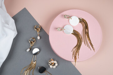 Stylish female jewelry on trendy pink gray background