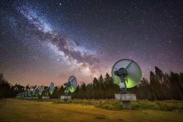 Milky way above astronomical antennas at solar observatory at night - 430297837