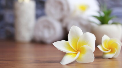 Obraz na płótnie Canvas close up of Plumeria Spa accessories,Beautiful composition of spa ,spa relax concept,beautiful sap set on wood table.