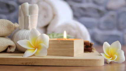 Fototapeta na wymiar Spa accessories,Beautiful composition of spa , spa relax concept, herbs for massage, beautiful sap set on wood table,close up of Plumeria Spa