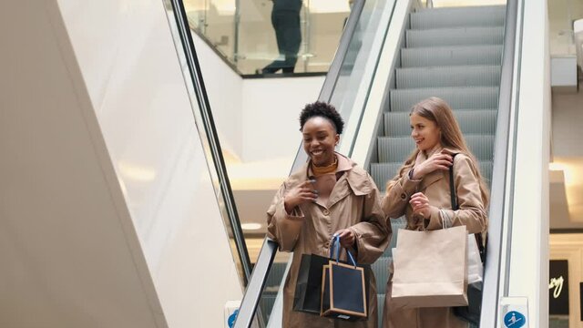 Beautiful girls are holding shopping bags and shopping in the mall