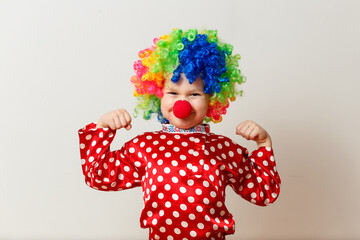 funny baby in clown costume on a white background