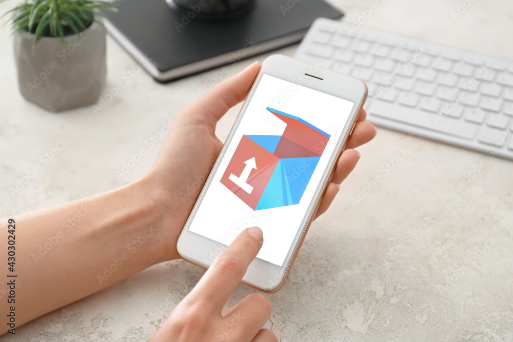 Poster woman using mobile phone with open page of delivery service application at table