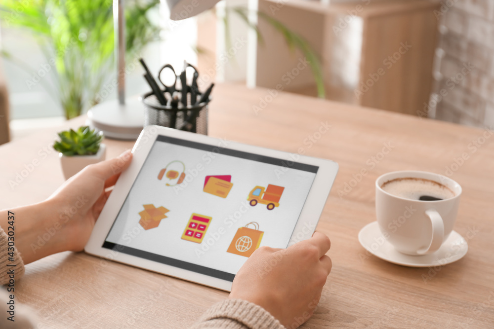 Poster woman using tablet computer with open page of delivery service application at home