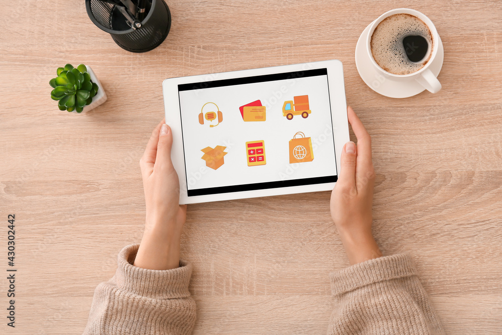 Poster woman using tablet computer with open page of delivery service application at table