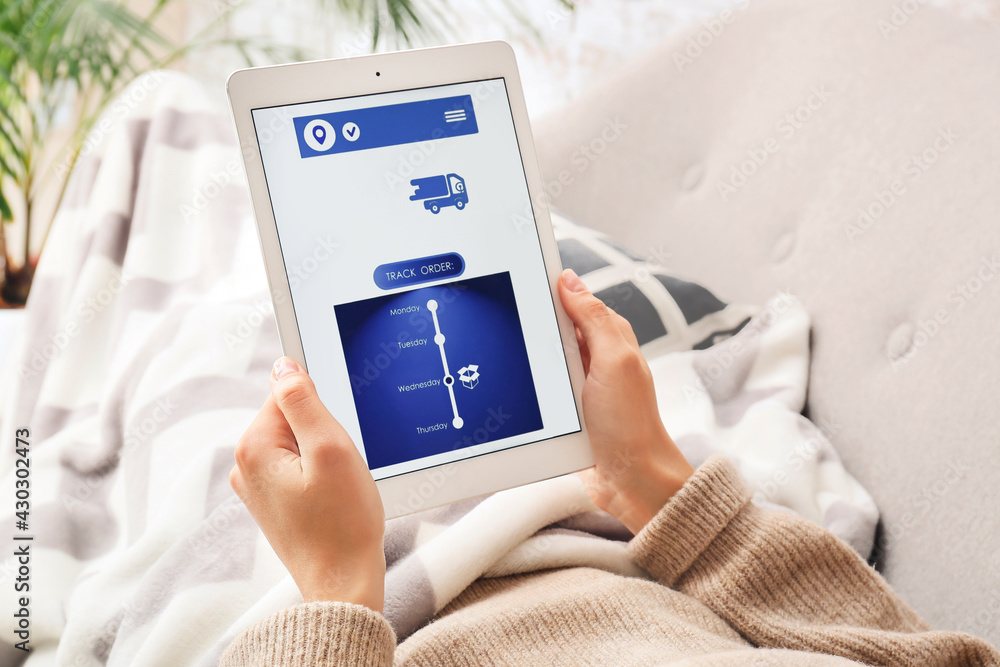 Poster woman holding tablet computer with open page of delivery service application at home