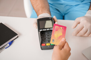Patient paying for consultation in clinic via terminal