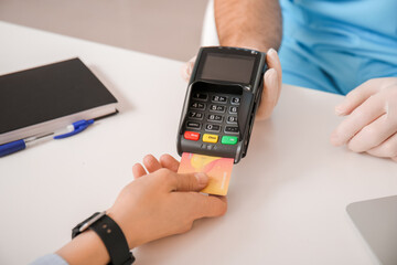 Patient paying for consultation in clinic via terminal