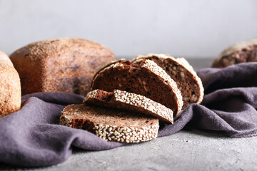 Fresh cut bread on grey background