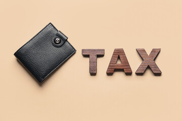 Wallet with word TAX on color background