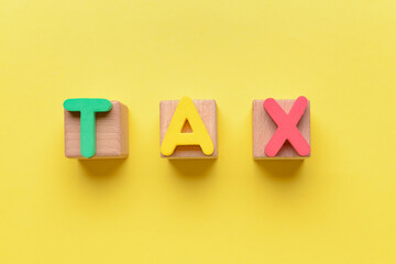 Cubes with word TAX on color background
