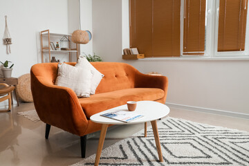 Stylish interior of living room with comfortable sofa and table