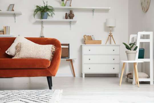 Stylish interior of living room with comfortable sofa