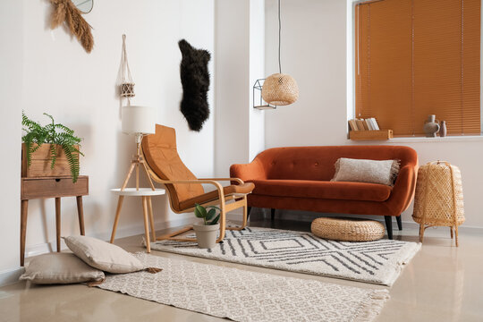 Stylish interior of living room with comfortable sofa