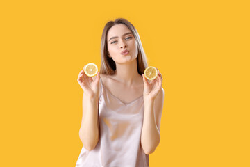 Fototapeta na wymiar Beautiful young woman with lemon on color background