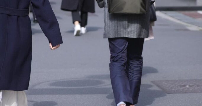 A high speed of body parts of walking people at urban city in Shinjuku
