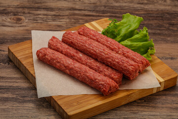 Raw beef sausages with spices