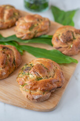 home made whole grain bread rolls with wild garlic on a table