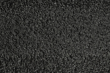 Black foam plastic background texture. black background for designers. dark styrofoam