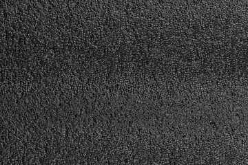 Black foam plastic background texture. black background for designers. dark styrofoam