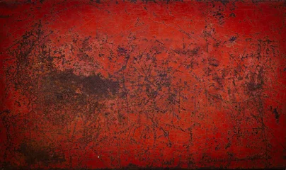 Foto op Canvas The surface of the old red metal is scratched and corroded to rust. © cabertiger