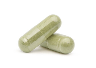 Close-up Two Andrographis paniculata powder capsules  isolated on white background.Clipping path.