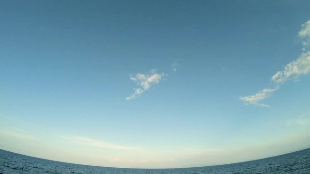 wide angle view panoramic of blue sky and the deep blue nevy blue ocean. drone fly scean over wide ocean. beautiful landscape of winter sky and sea.