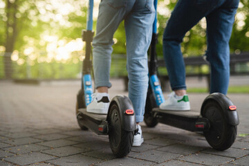 Mother and daughter riding electric scooters