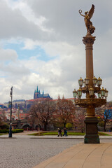 Fototapeta na wymiar Rudolfinums column in Prague with St. Vitus cathedral in background, Czech Republic.