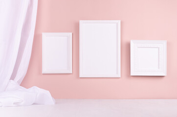 Calm pastel pink interior with set of white blank photo frames for text, design, poster, pictures...