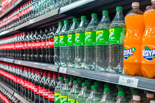Manila, Philippines - July 2020: A row of Coke products on display at an aisle in a supermarket. Coca Cola, Coke Zero, Sprite and Royal.