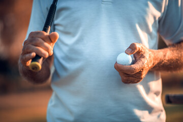 Senior golfer standing on court. Close up.