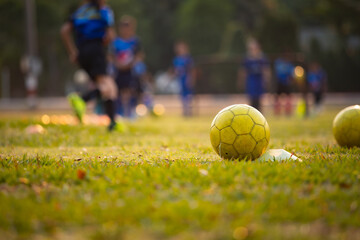Soccer balls on the field. Footballs for practice put on the green grass.