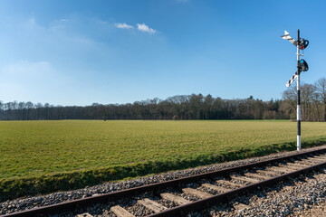 Fototapeta na wymiar Museum railway leading from Loenen towards Beekbergen with classical sign in Th Netherlands near Loenen on VSM railway.