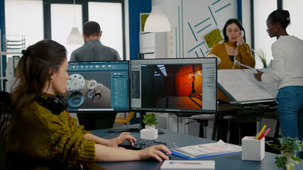 Engineer analysing cad software to develop video game, working in startup creative company for...