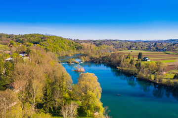 Fototapeta na wymiar Mreznica river in Croatia from air, drone view of Belavici village in spring