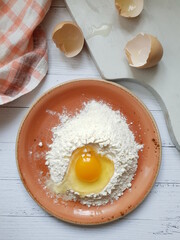 Still life with flour, egg on the kitchen table