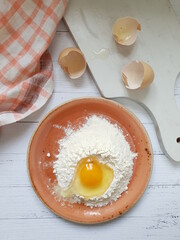 Still life with flour, egg on the kitchen table
