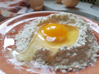 Still life with flour, egg on the kitchen table
