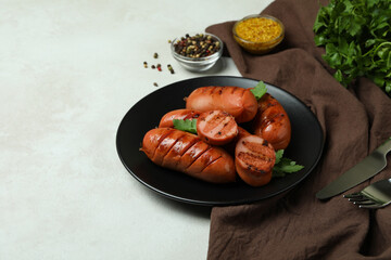 Concept of tasty food with grilled sausage on white textured background