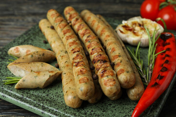 Concept of tasty food with grilled sausage on wooden table