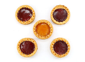 Tart type jam pastries on a white background. Jam flavors are apricot, strawberry and berry 