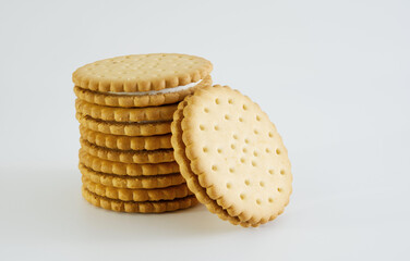 A few stacked cream-filled biscuits with one slanted, sweet food