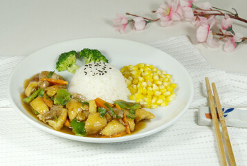 Chicken rice with corn and broccoli, a pair of chopsticks, Chinese traditional food