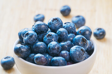 Close-up of fresh blueberries in a white bowl, healthy concept