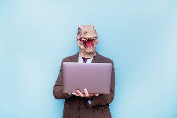 Euphoric man with lizard head with laptop on blue background