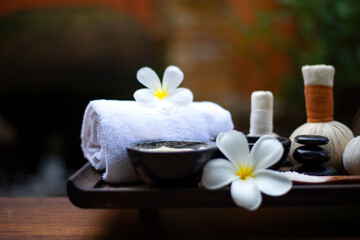 Fototapeta na wymiar Spa Thai setting for aroma therapy and sugar and salt massage with flower on the bed, relax and healthy care. Healthy Concept