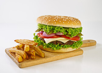 Hamburger, vegetables, beef, onion rings, french fries on a cutting board, white background