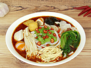Spicy udon noodles with crab sticks, enoki mushroom, spinach, red pepper, black fungus. Nutritious, healthy and delicious food